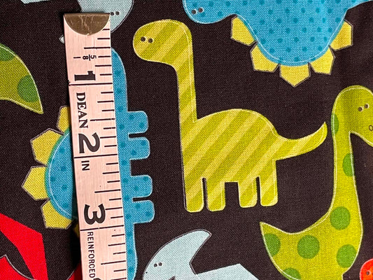 Robert Kaufman Urban Zoologie. Dinosaurs on black background.  Sold by the yard.