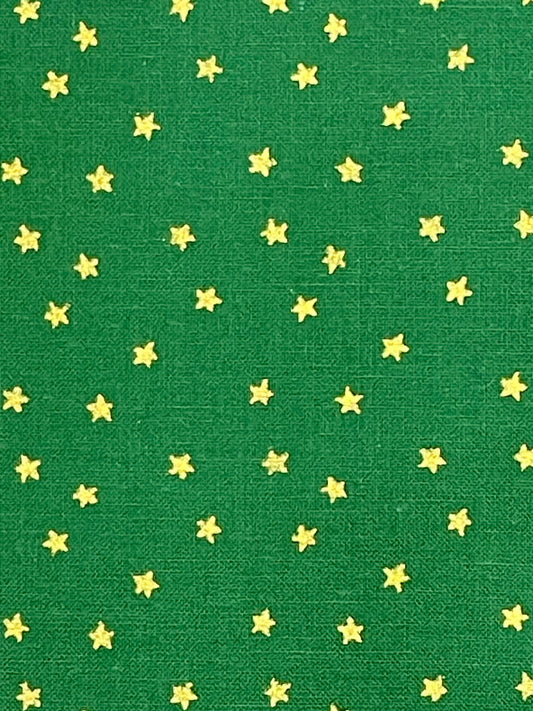 Gold stars on dark green background.  Sold by the yard