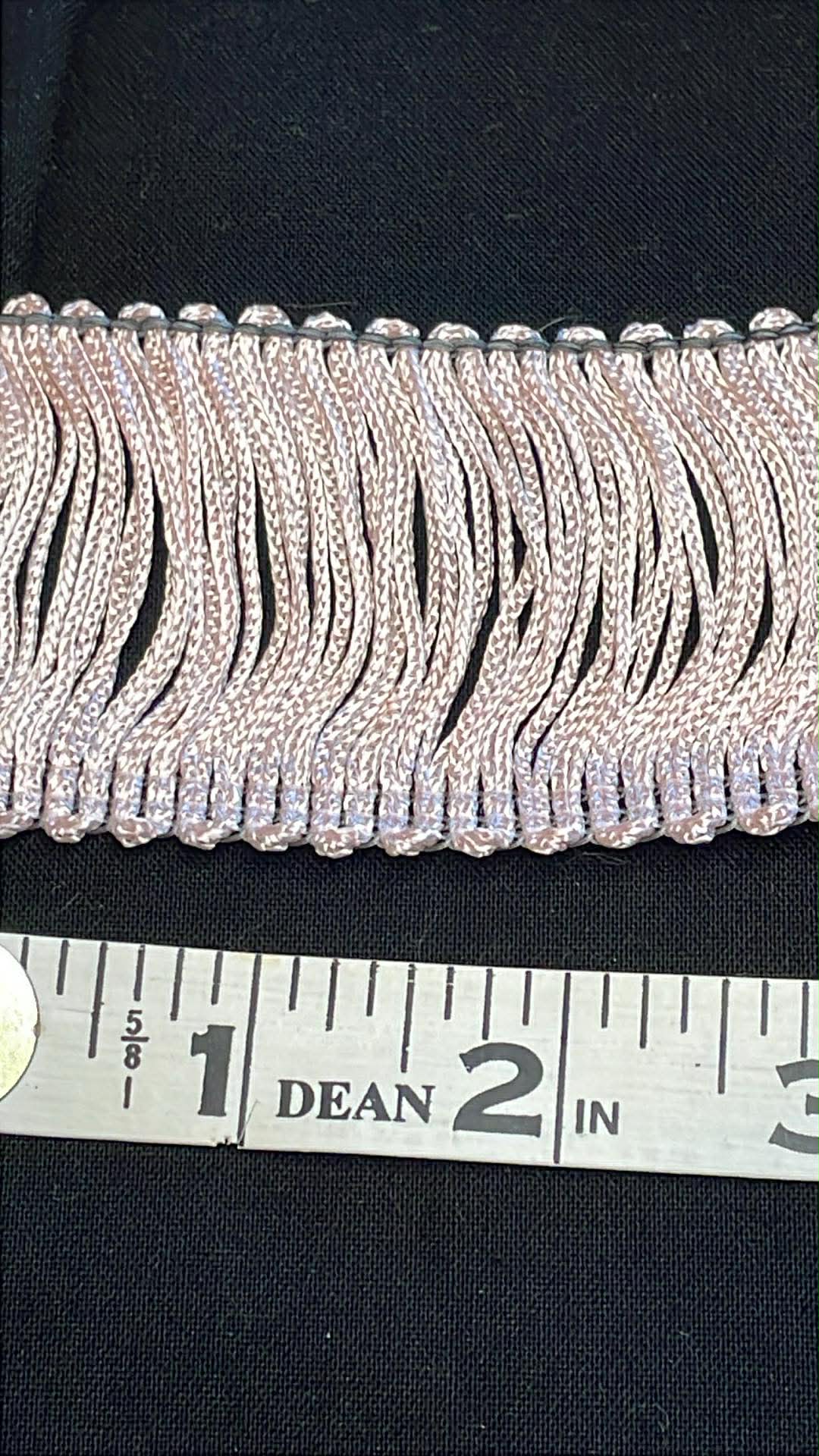 2" wide pink rayon chainette trim.  Sold by the half yard.