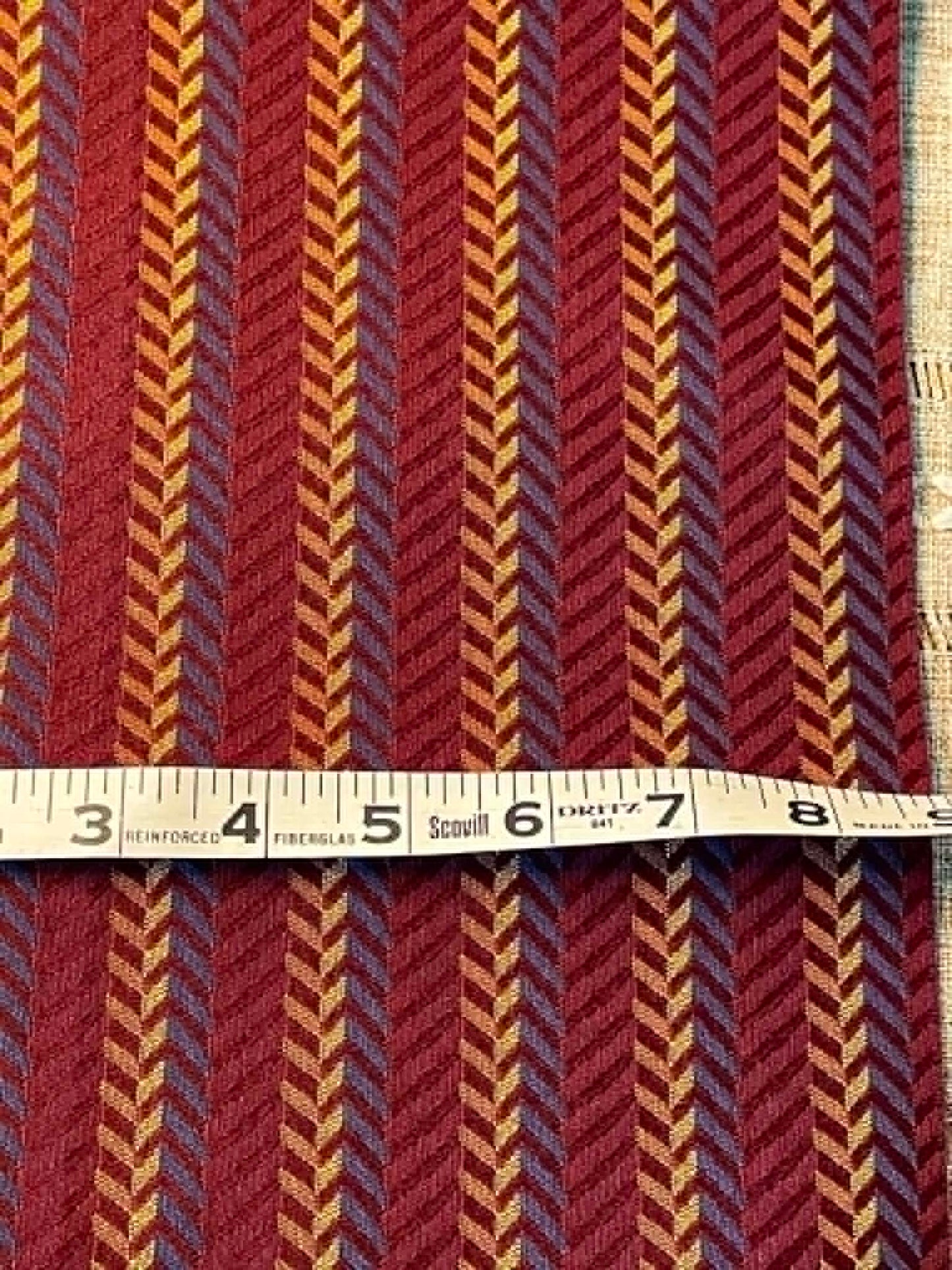 Maroon, blue and tan zigzag jacquard upholstery fabric.  58" wide.  Sold by the yard.