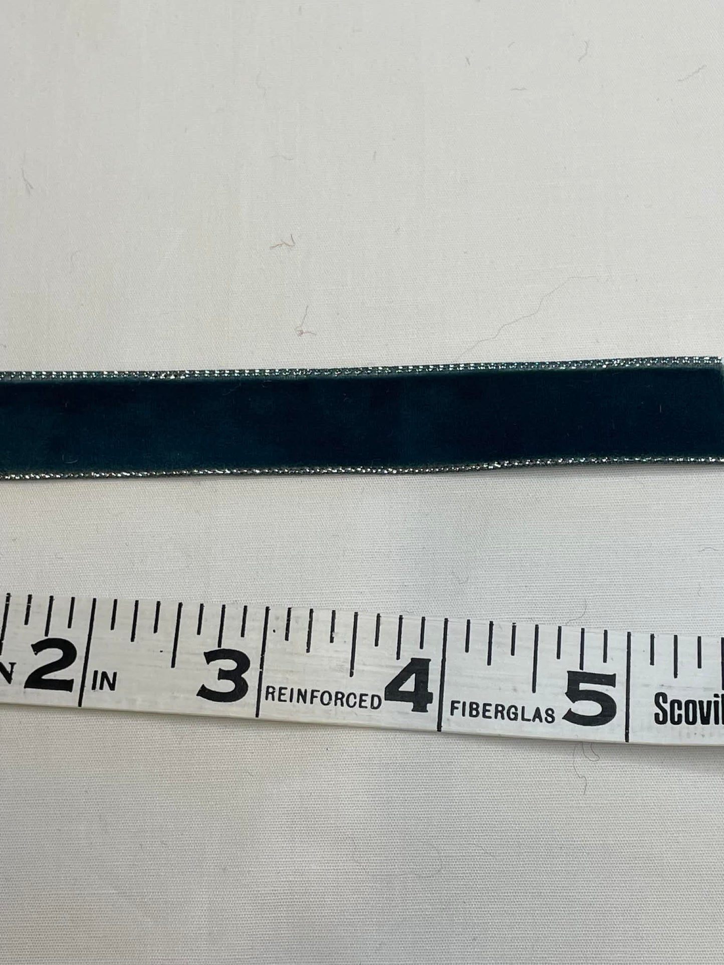 .625" greenish gray velvet ribbon w/ silver edges.  Sold by the yard.