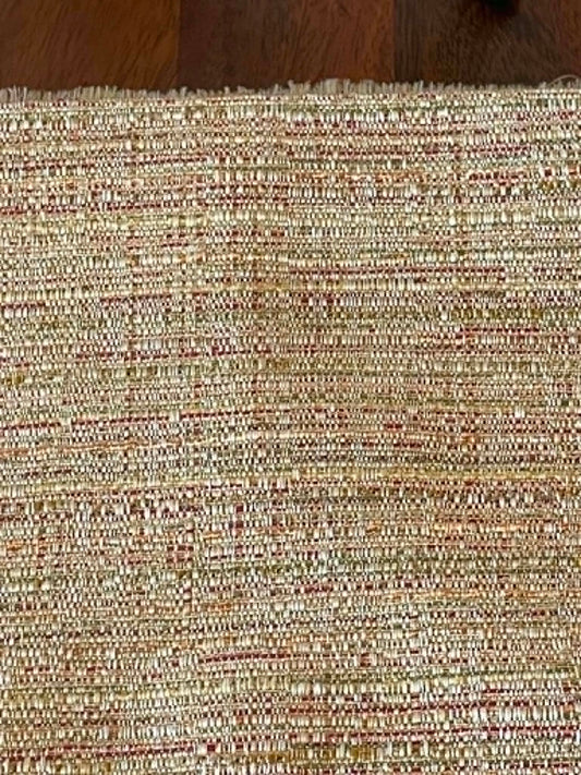 Pale yellow with some red and green.  Upholstery fabric.  Sold by the yard.