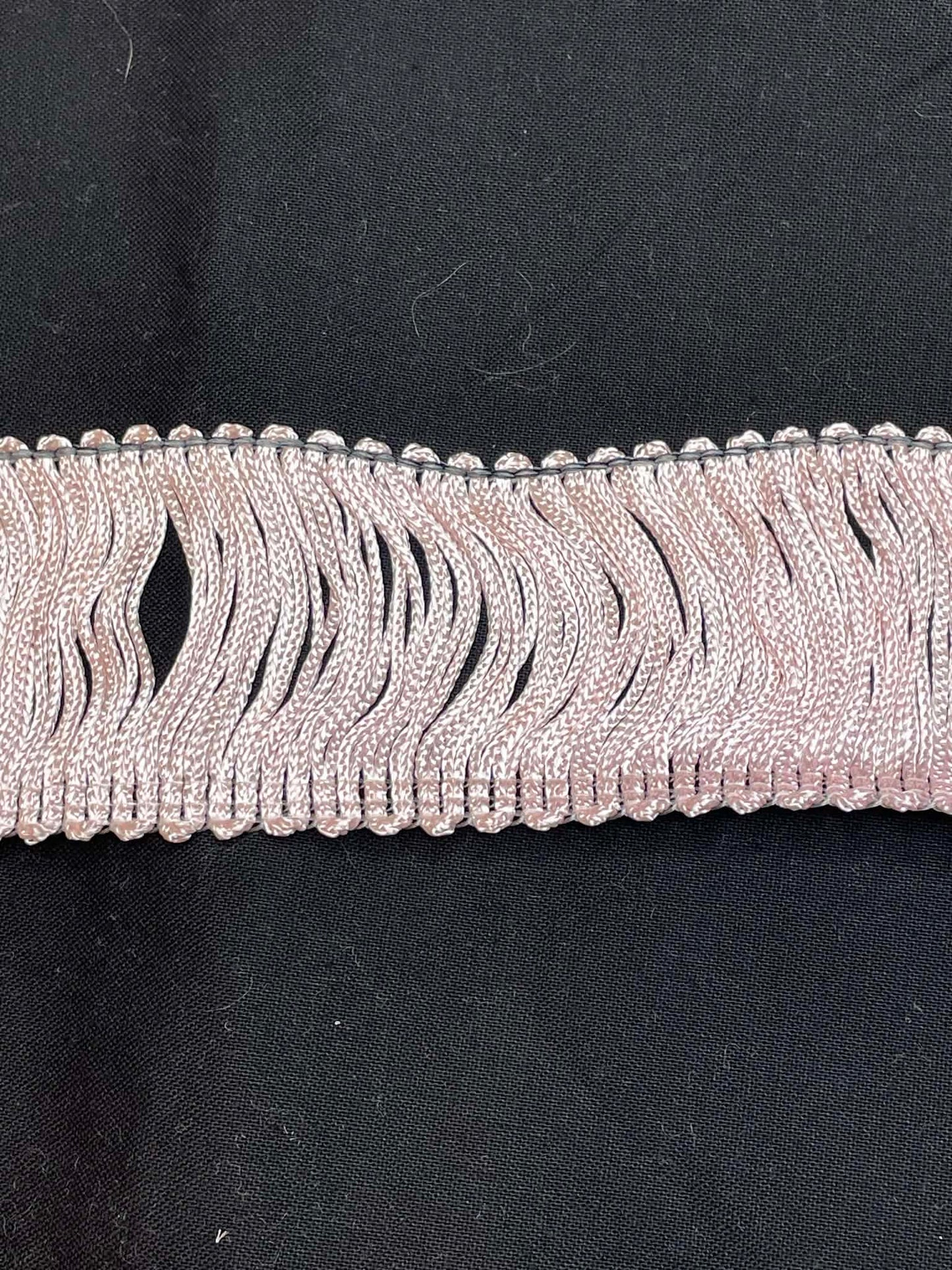 2" wide pink rayon chainette trim.  Sold by the half yard.