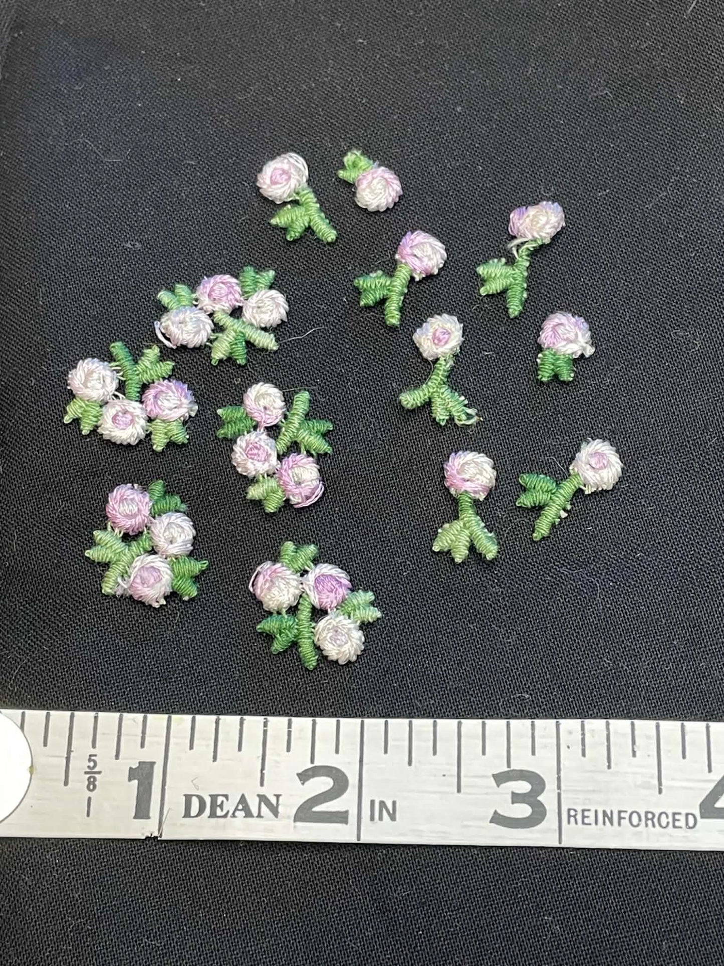 13 tiny embroidered flowers applique sold as a group.