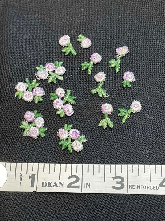13 tiny embroidered flowers applique sold as a group.