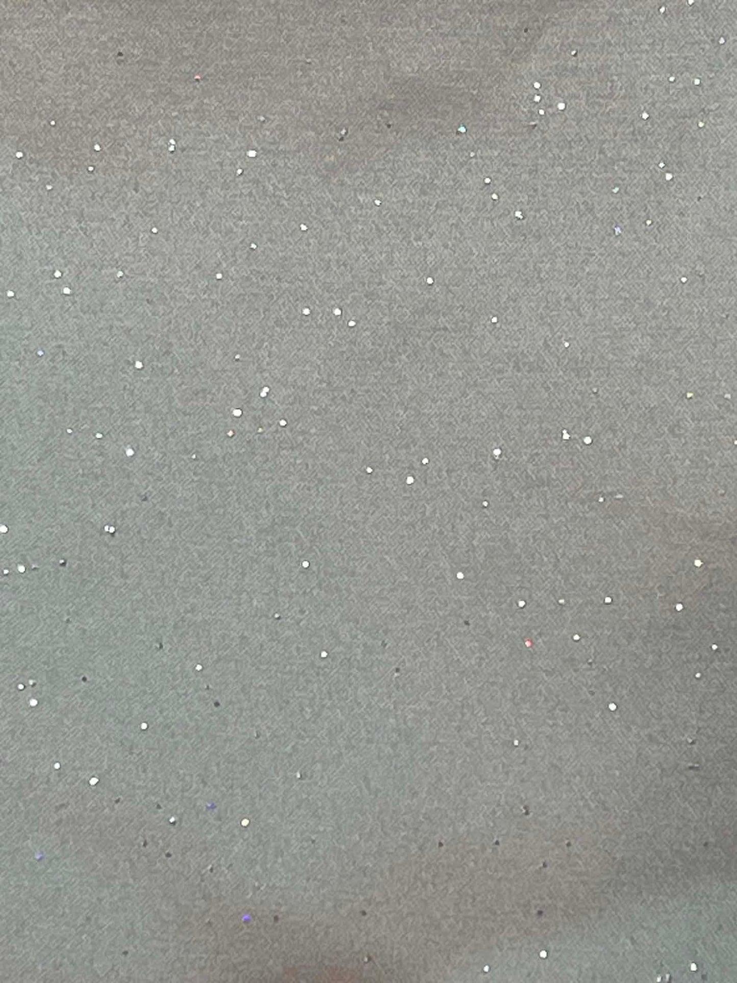 Gray satin with multi-colored sparkles throughout.  Sold by the yard.