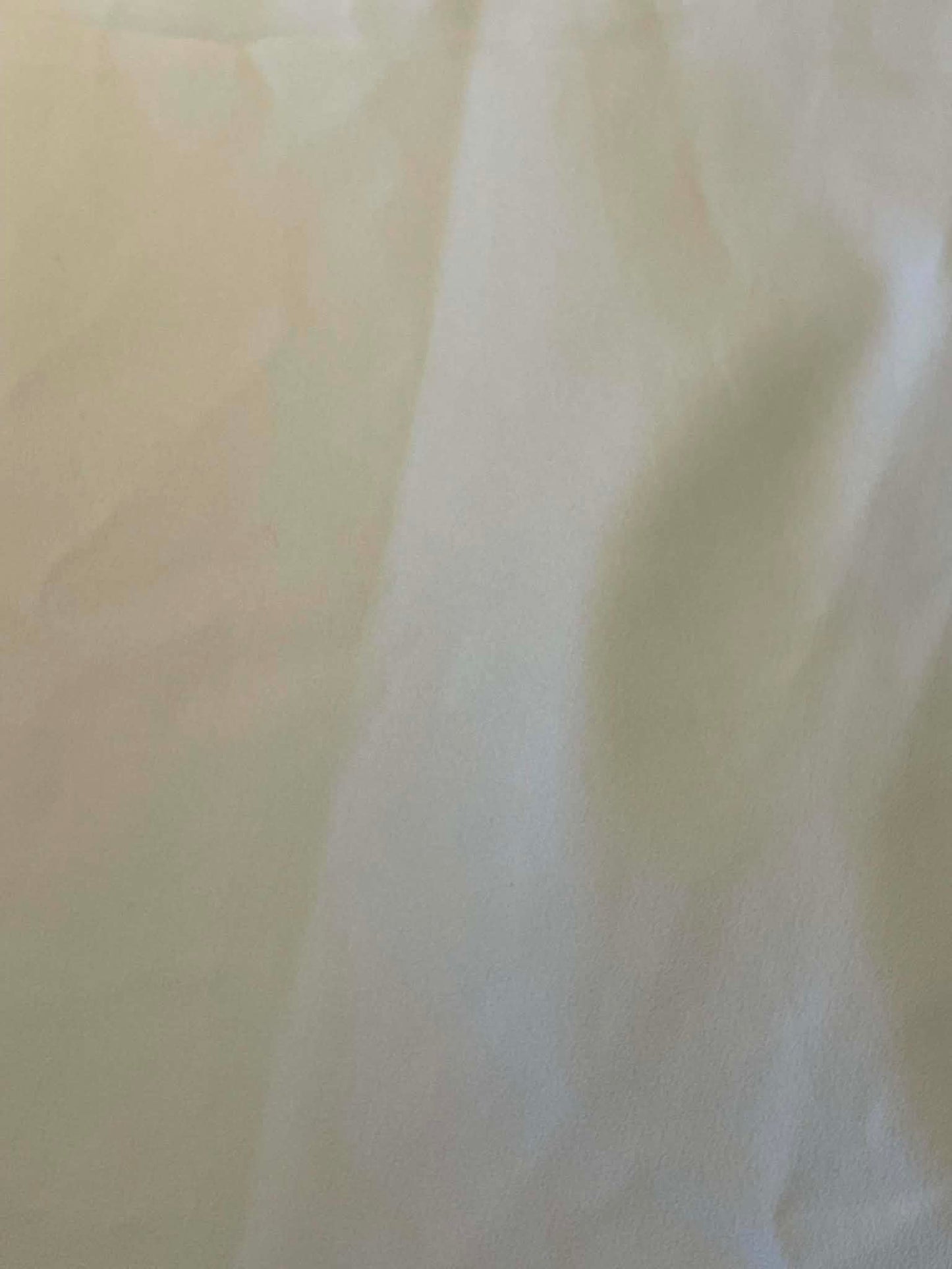 Off white polyester crepe.  Sold by the yard.