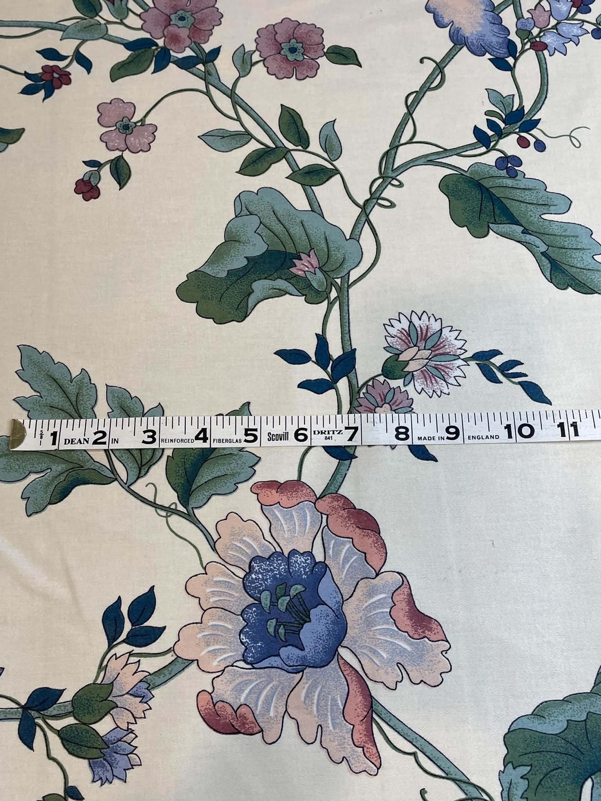 Blue, green and peach floral on white.  Upholstery fabric.  Sold by the yard.