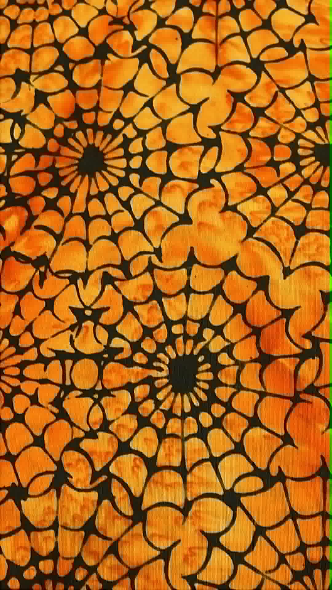 Island Batik - Spiders on Orange - Sold by the half yard.