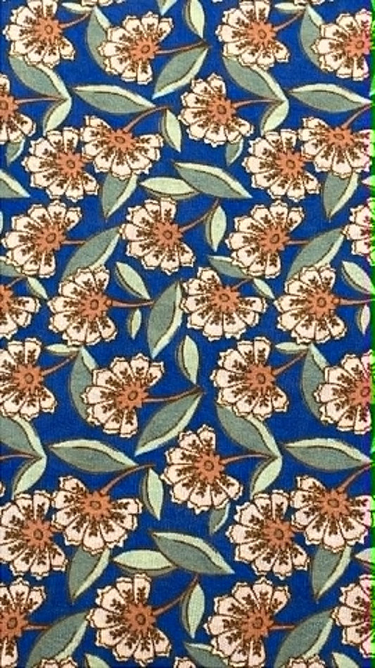 Beige and brown flowers on blue background.  Crepe.