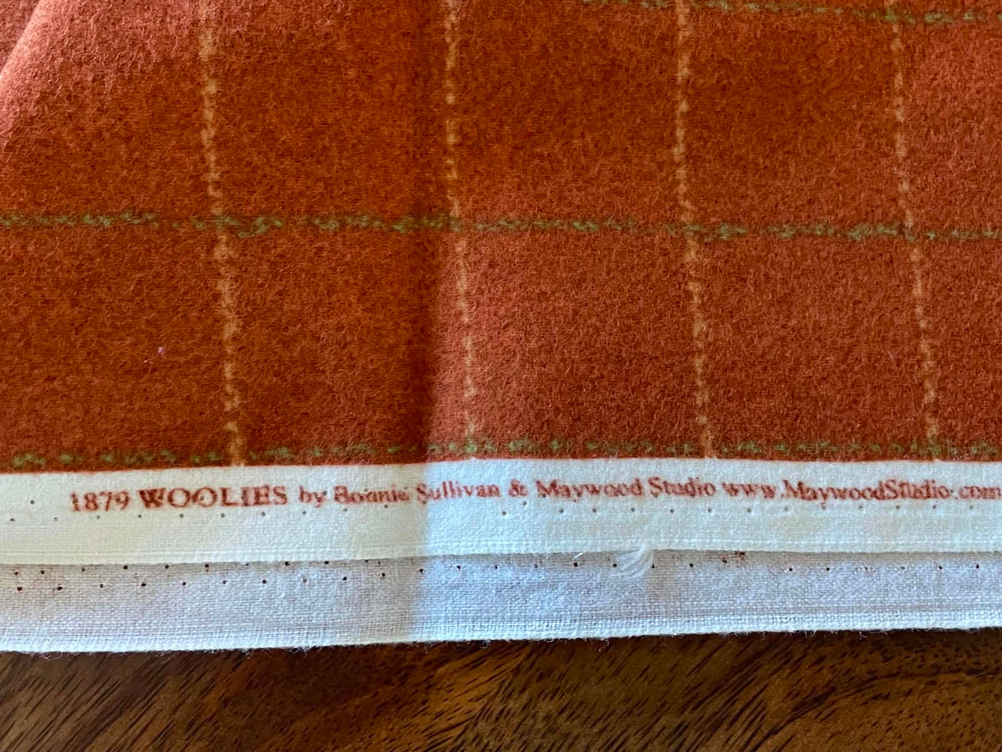 Flannel.  1879 Woolies.  Orange Plaid.   Sold by the yard.