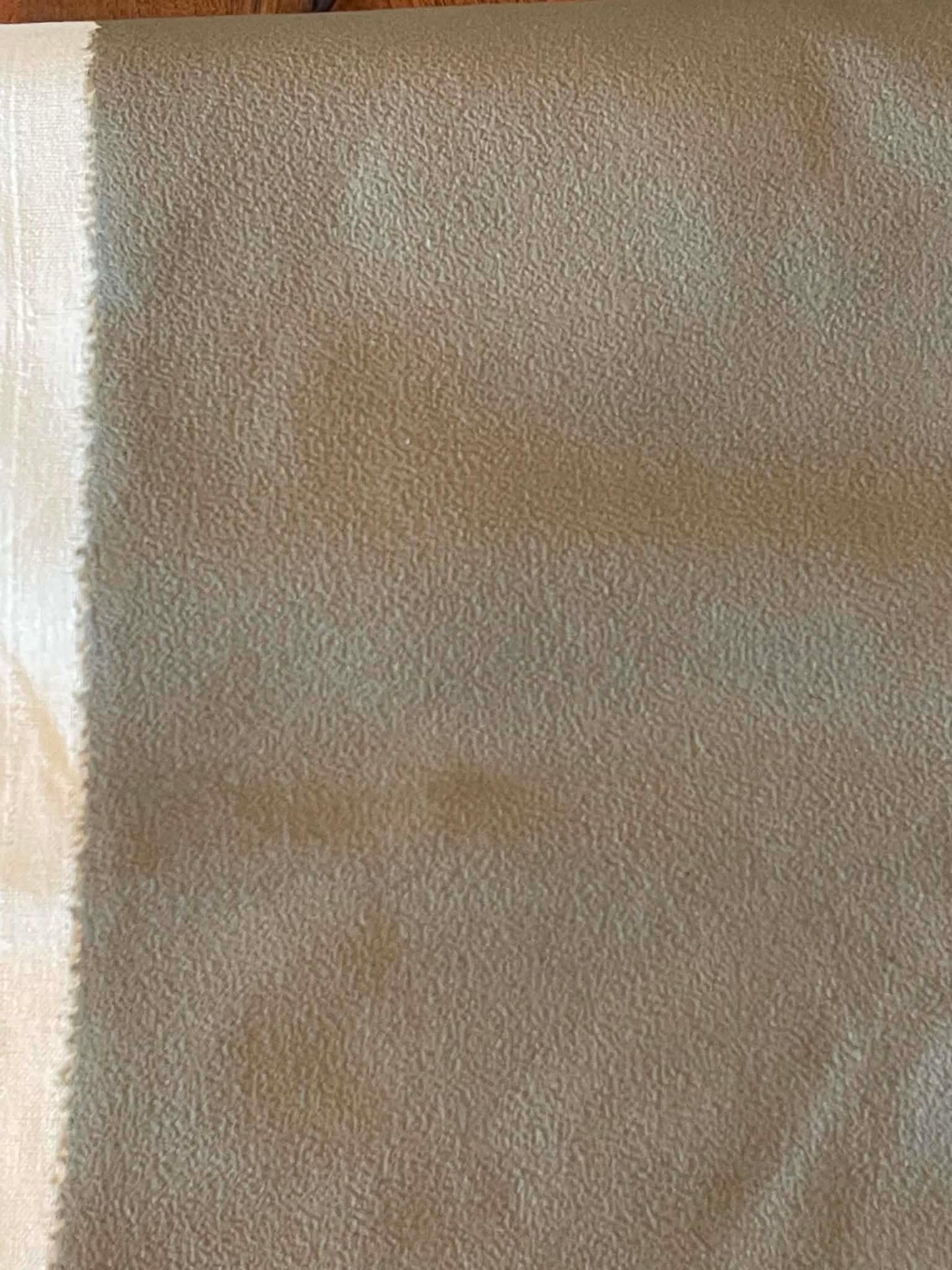 Dark green, suede like upholstery fabric.  Sold by the yard.