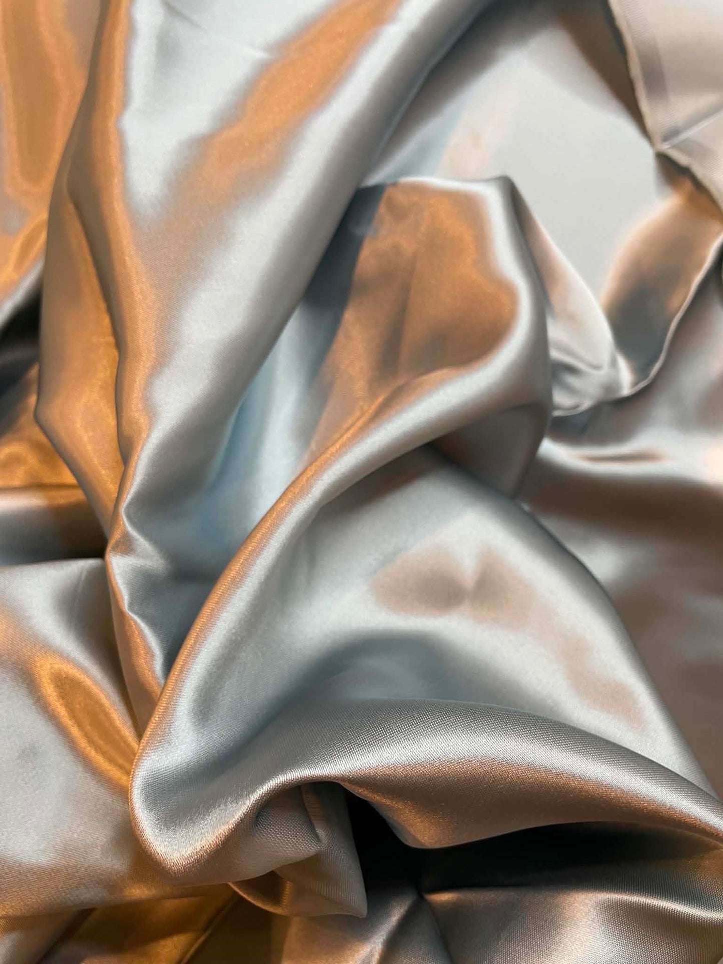 Light silver blue satin.  Sold by the yard.