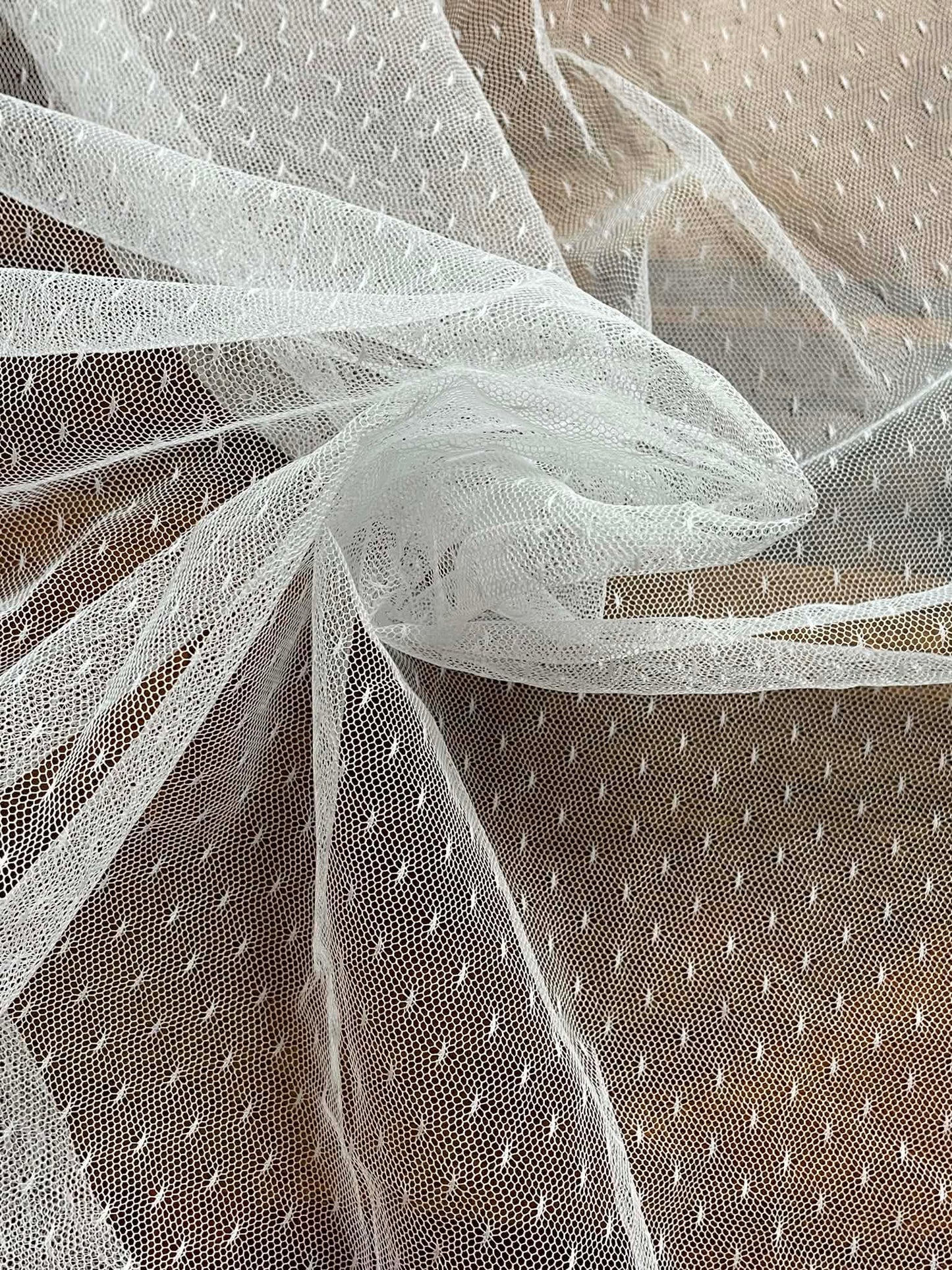 White mesh with pattern white specks.  Sold by the yard.