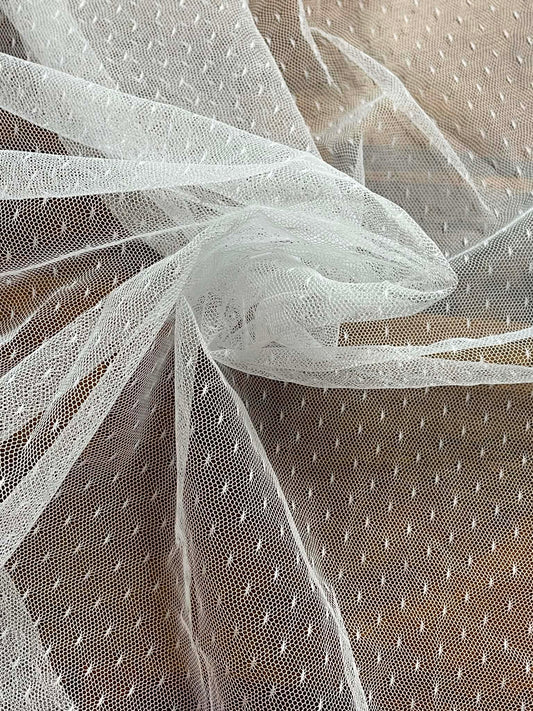 White mesh with pattern white specks.  Sold by the yard.