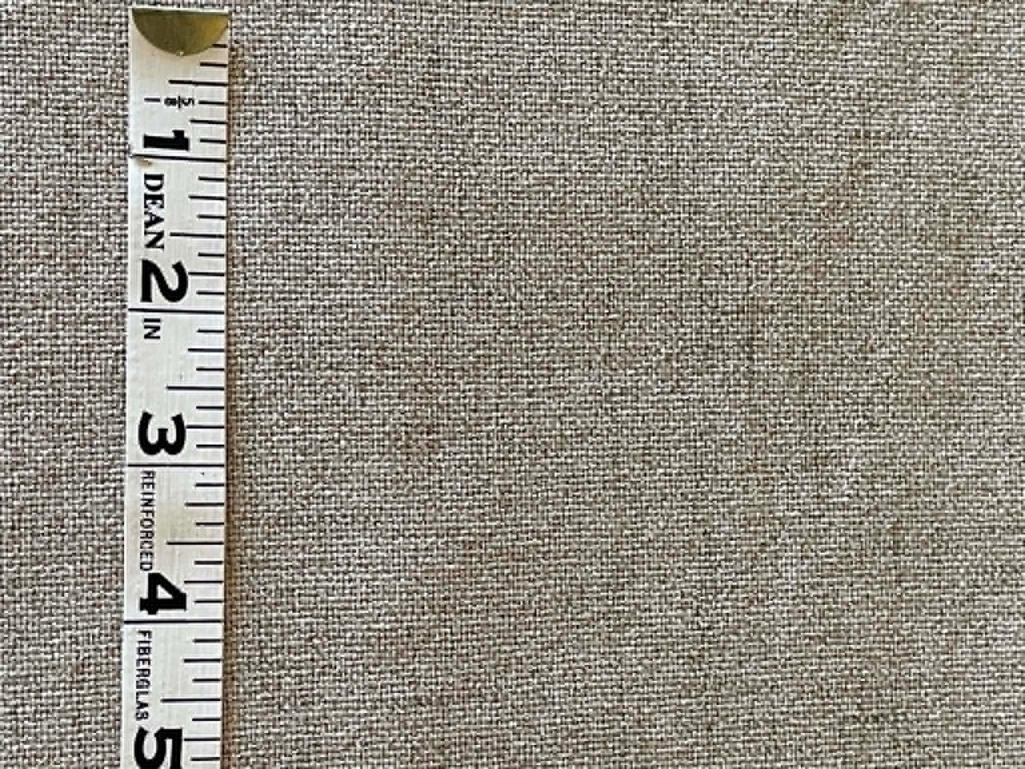 Grayish, off white upholstery fabric with white felt backing.  Sold by the half yard.