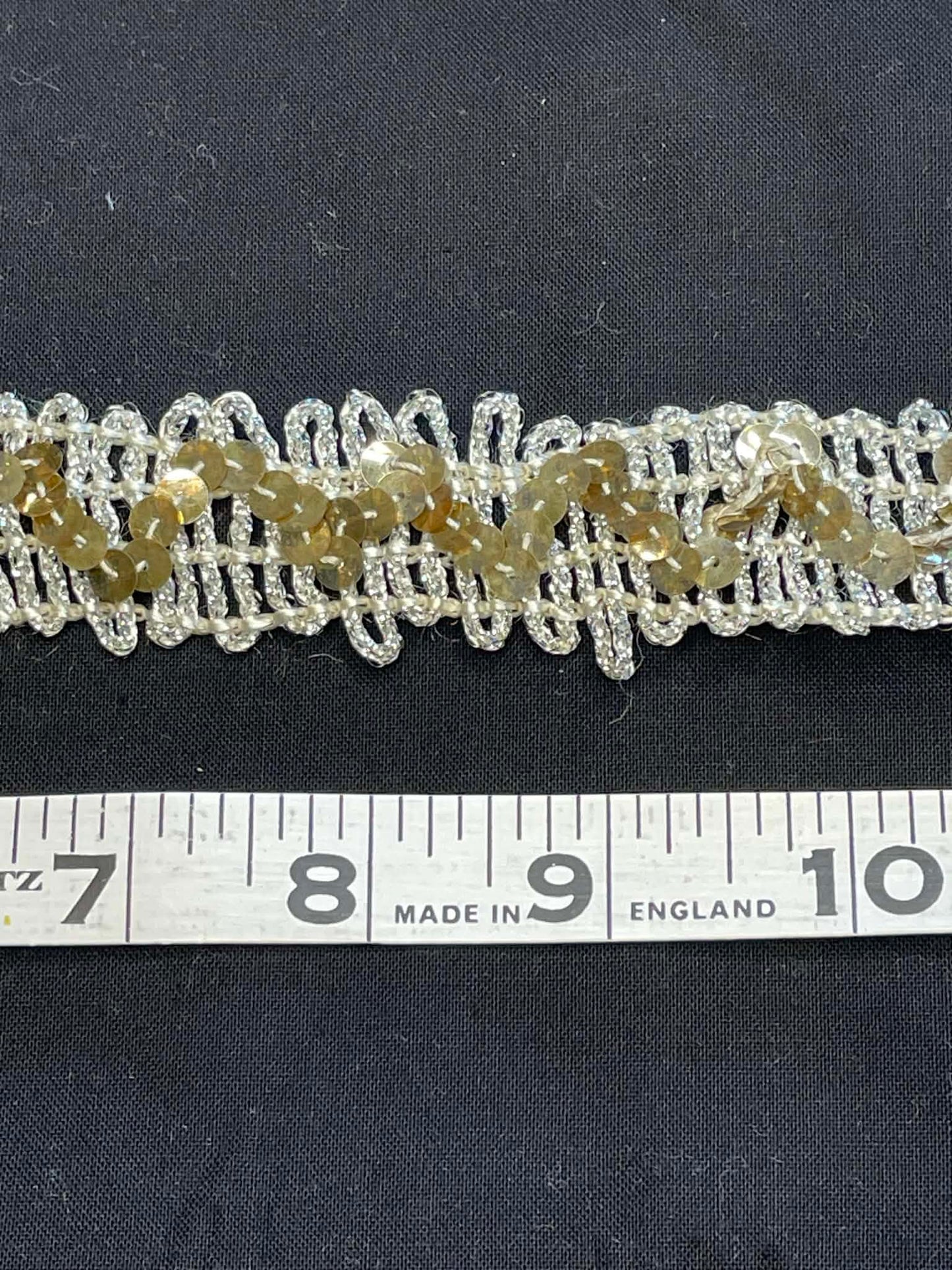 1 1/4" wide stretch sequin trim.  Sold by the half yard.