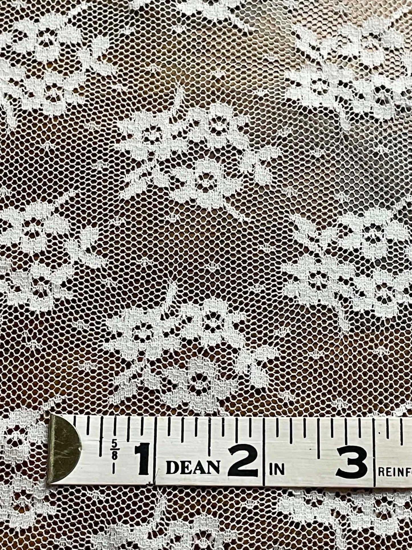 White floral all over lace.  Sold by the half yard.