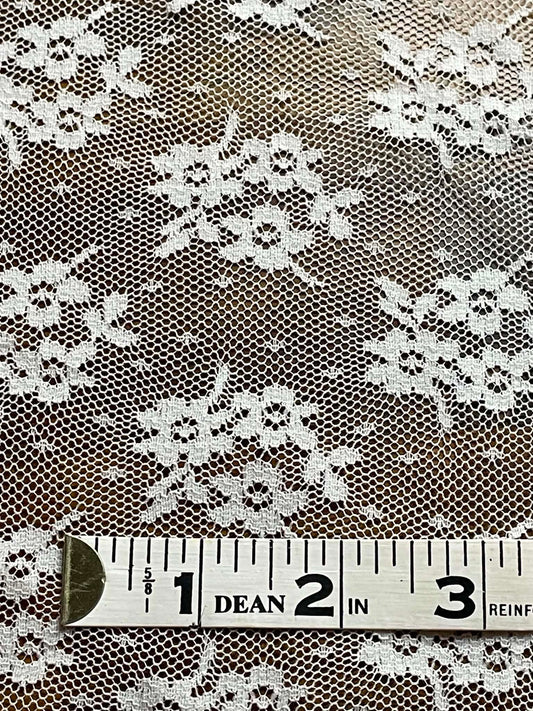 White floral all over lace.  Sold by the half yard.