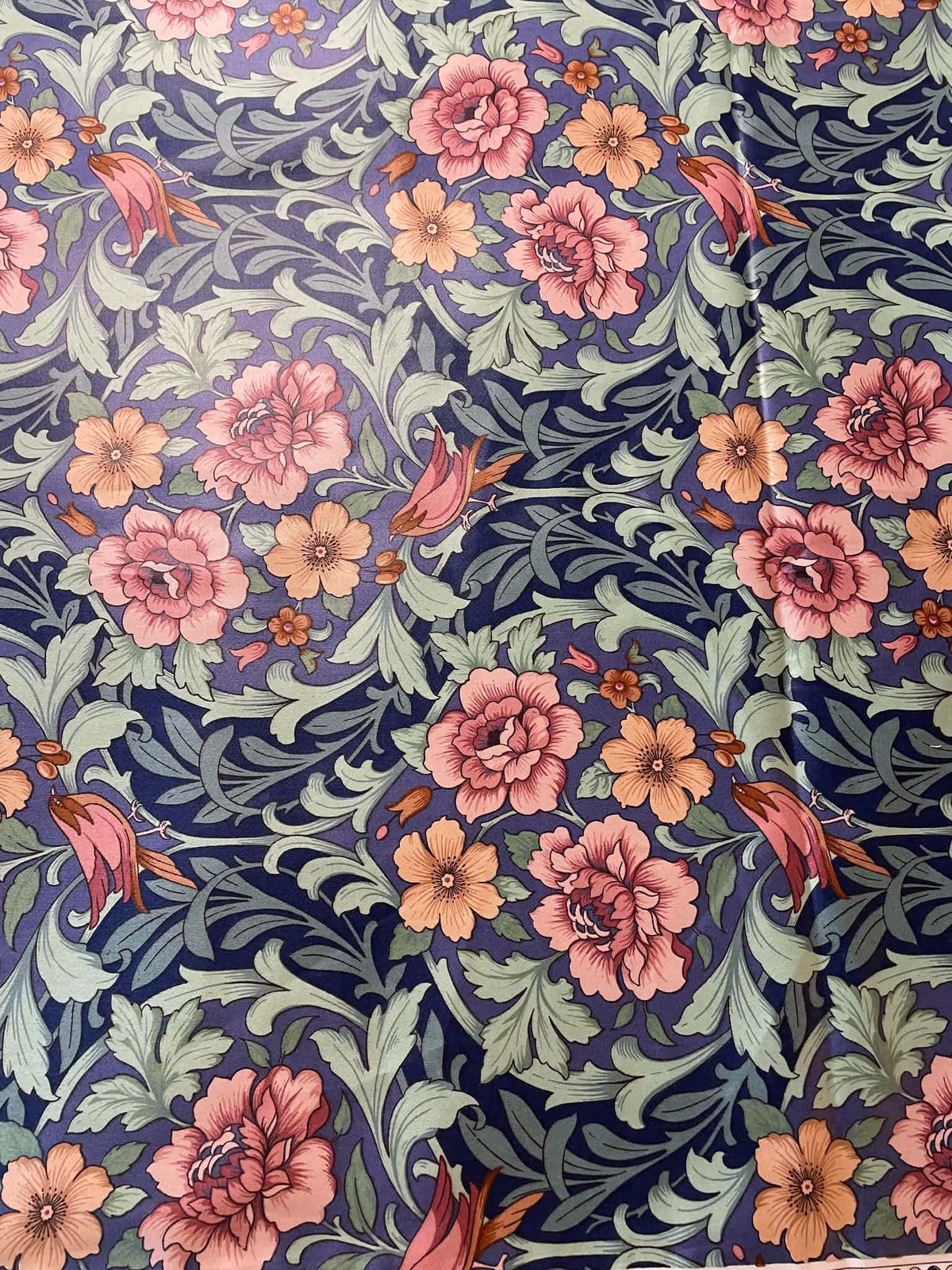 Interior upholstery fabric.  Peach and pink floral with a nice sheen.  Sold by the yard.