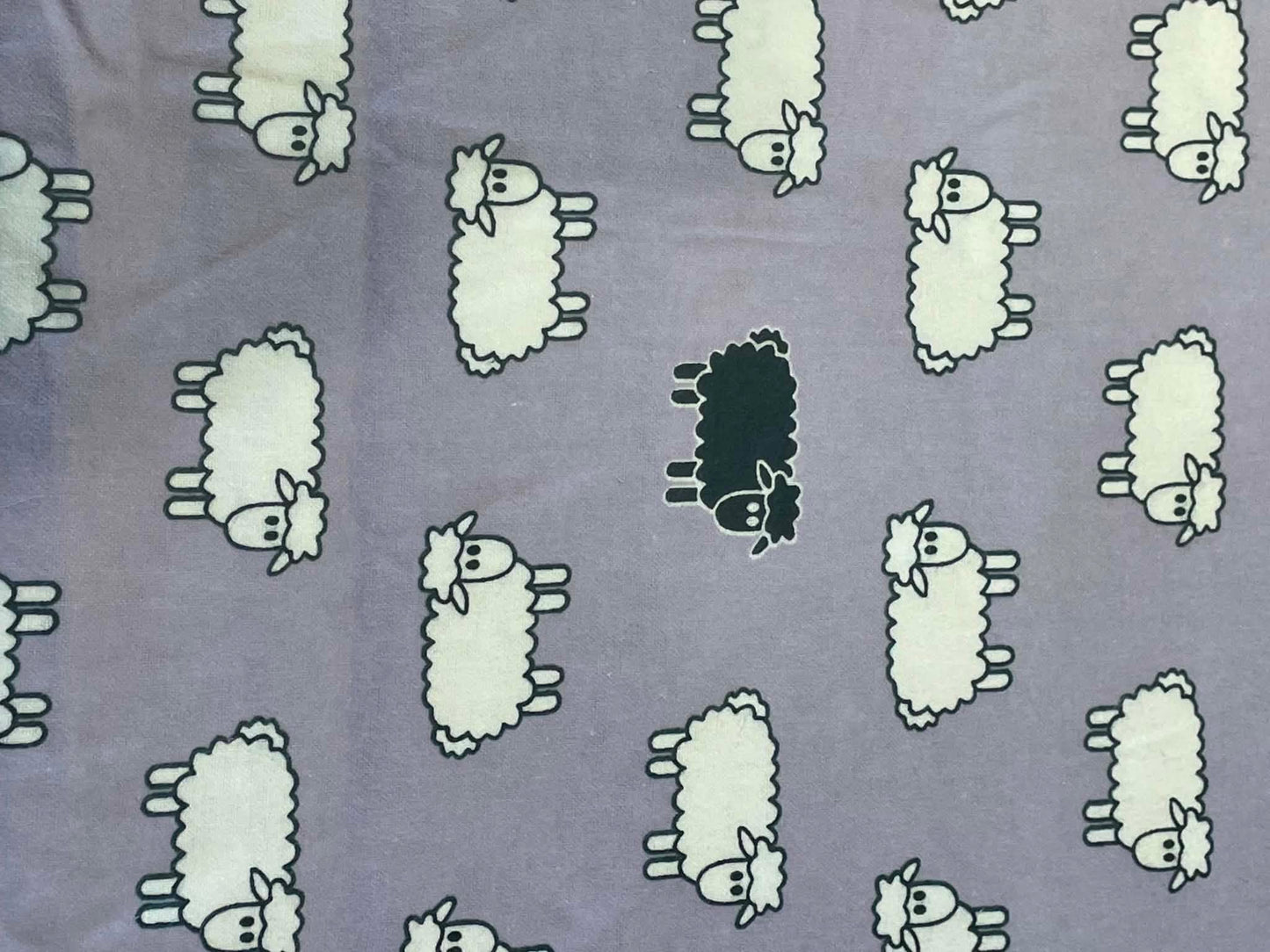Flannel.  Sheep on lavender background.  Sold by the half yard.