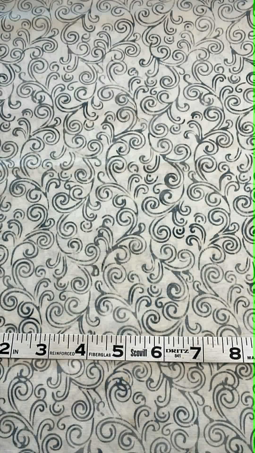 Bluish gray swirls on white background.  Sold by the half yard.