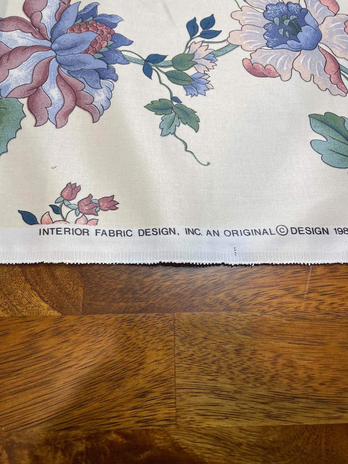 Blue, green and peach floral on white.  Upholstery fabric.  Sold by the yard.