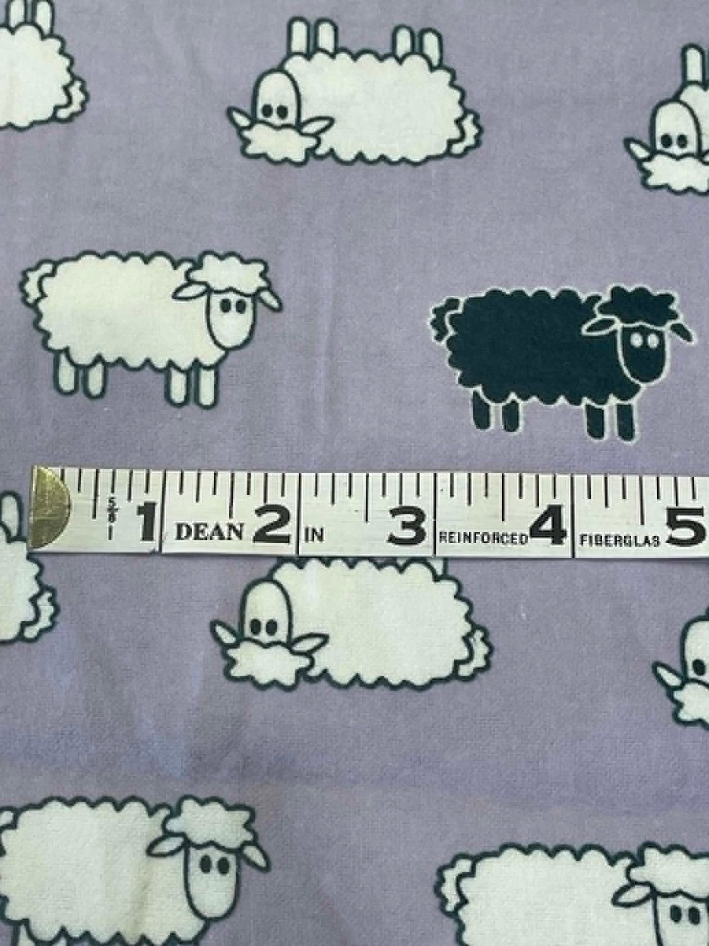 Flannel.  Sheep on lavender background.  Sold by the half yard.