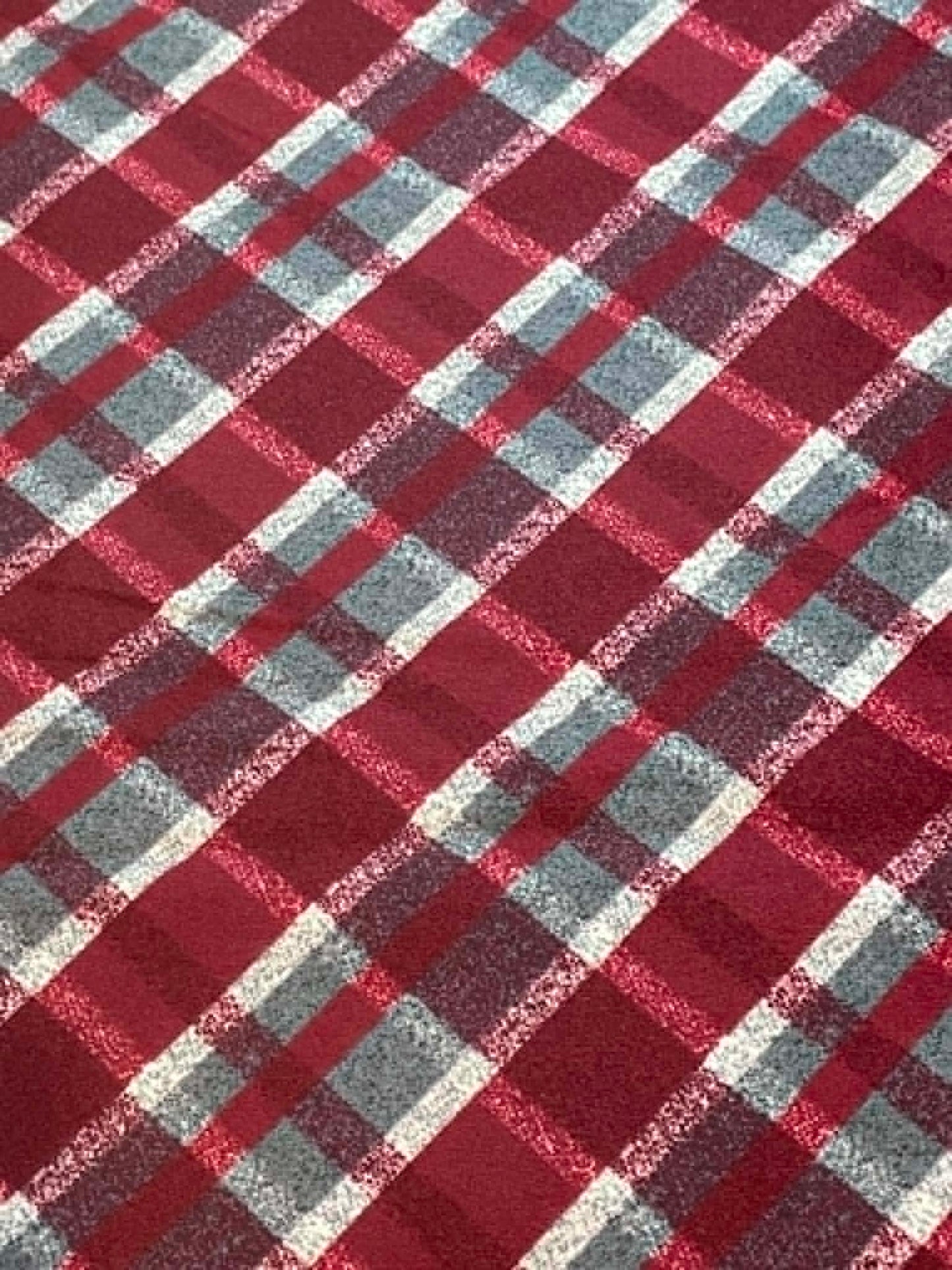 Red, gray and white plaid flannel.  Sold by the yard.
