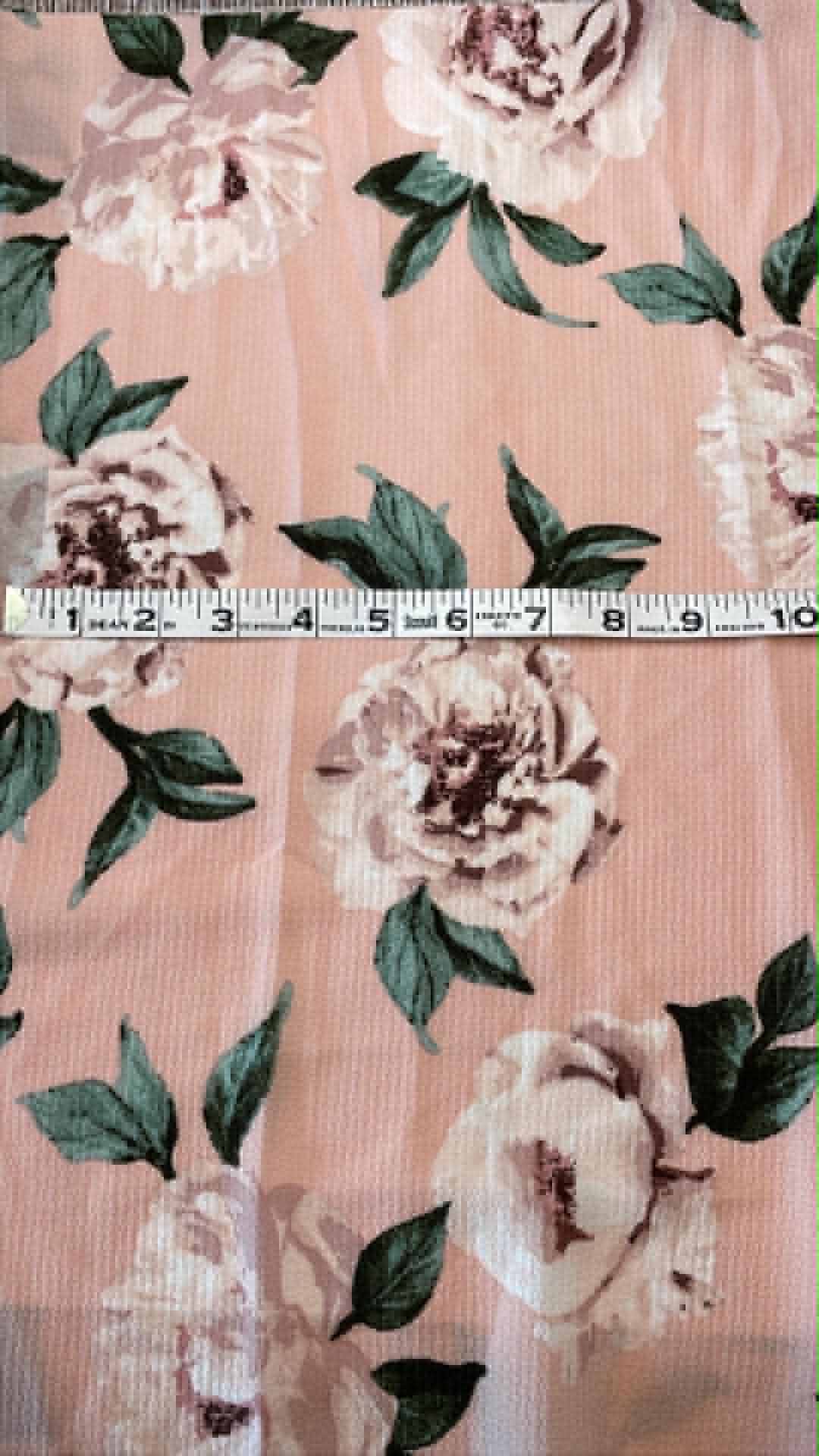 Light colored roses on light pink background.  Sold by the half yard.