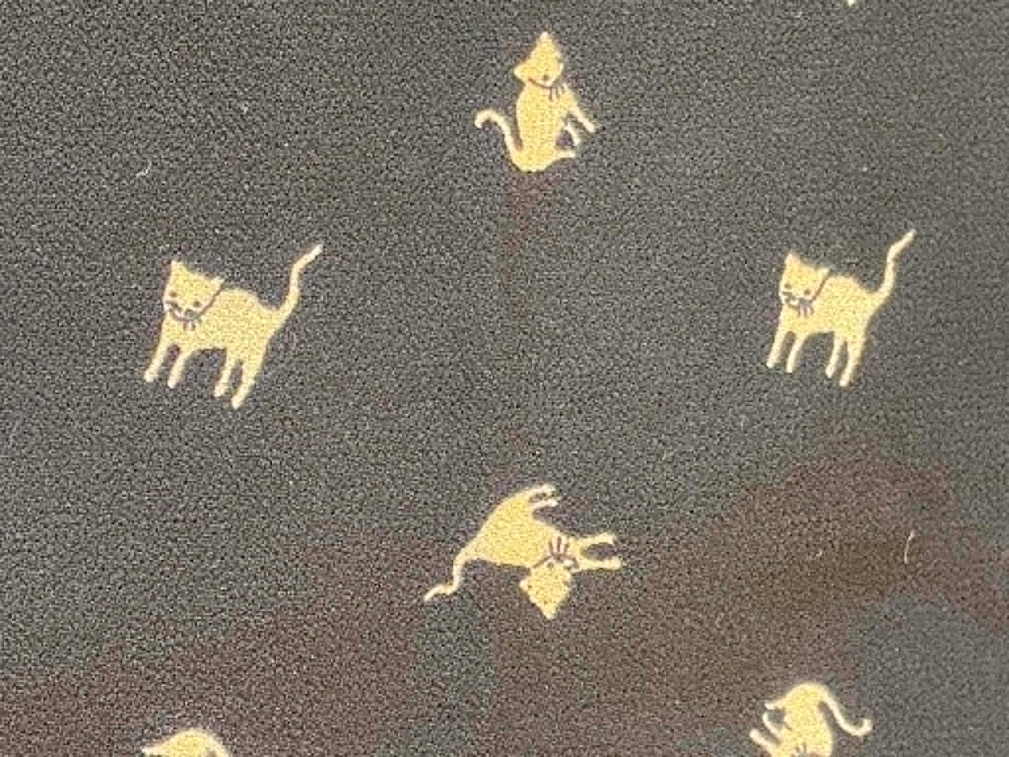 Crepe tan cats on black background.  Sold by the 1/2 yard.