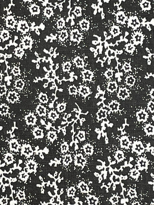 White floral calico on black background.  Sold by the yard.
